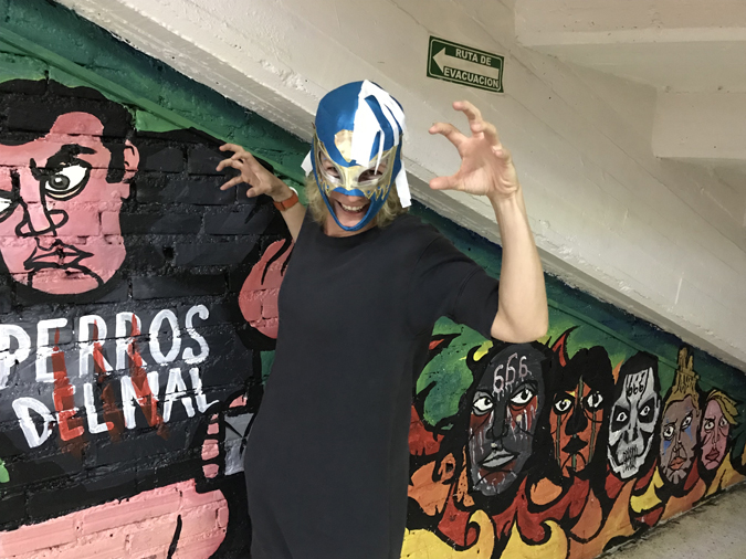 A crazy woman posing in a lucha libre mask